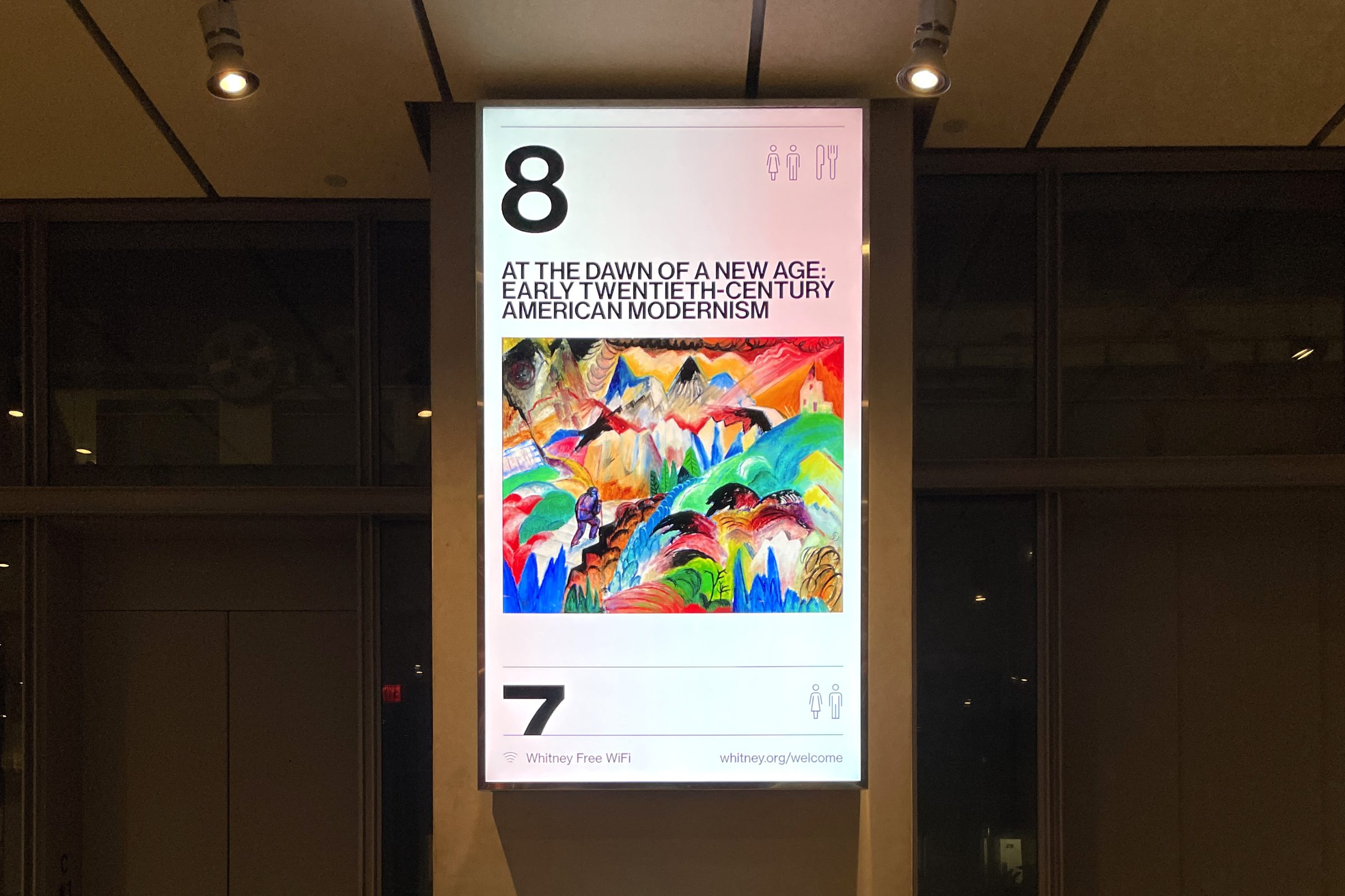 Large digital screen in the lobby of the whitney museum, displaying content from the 8th floor.